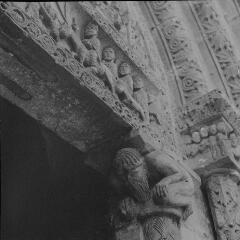 Pompierre - église Saint-Martin. – Vue rapprochée sur le fronton du portail ; linteau représentant l'Entrée à Jérusalem, chapiteau représentant un homme barbu.
