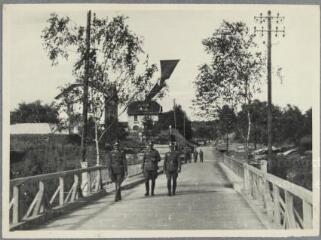 1 vue  - Seconde guerre mondiale.– Groupe de trois officiers de la Wehrmacht franchissant le pont \'Major Rothe\' établi sur la Moselle à Portieux. À noter : une bannière à croix gammée a été installée. (ouvre la visionneuse)